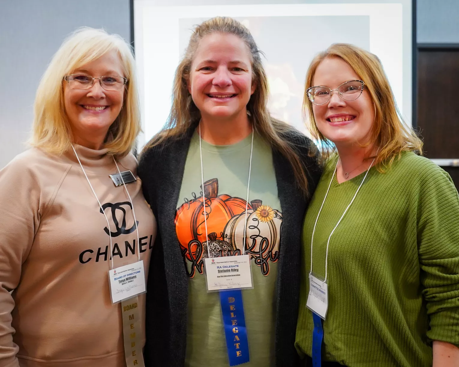 Three delegates at the 2023 AEA RA smile for a picture.