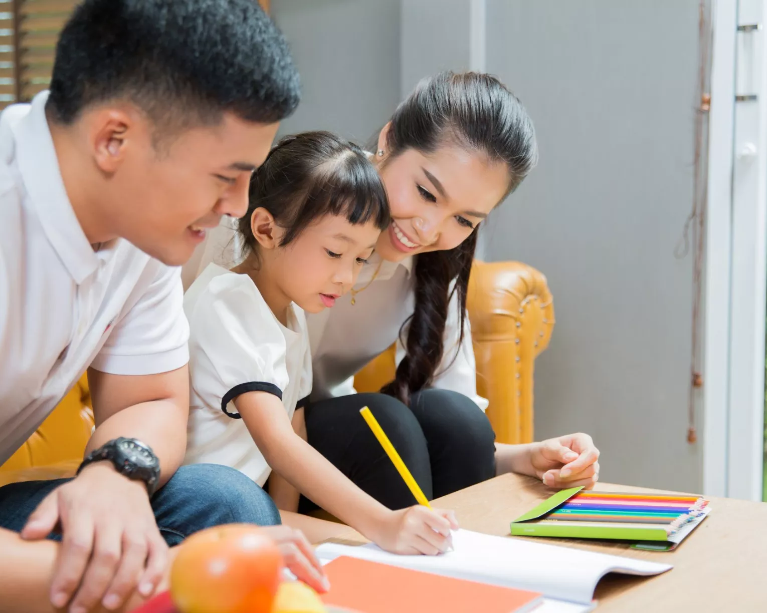 a family doing homework with an elementary school student