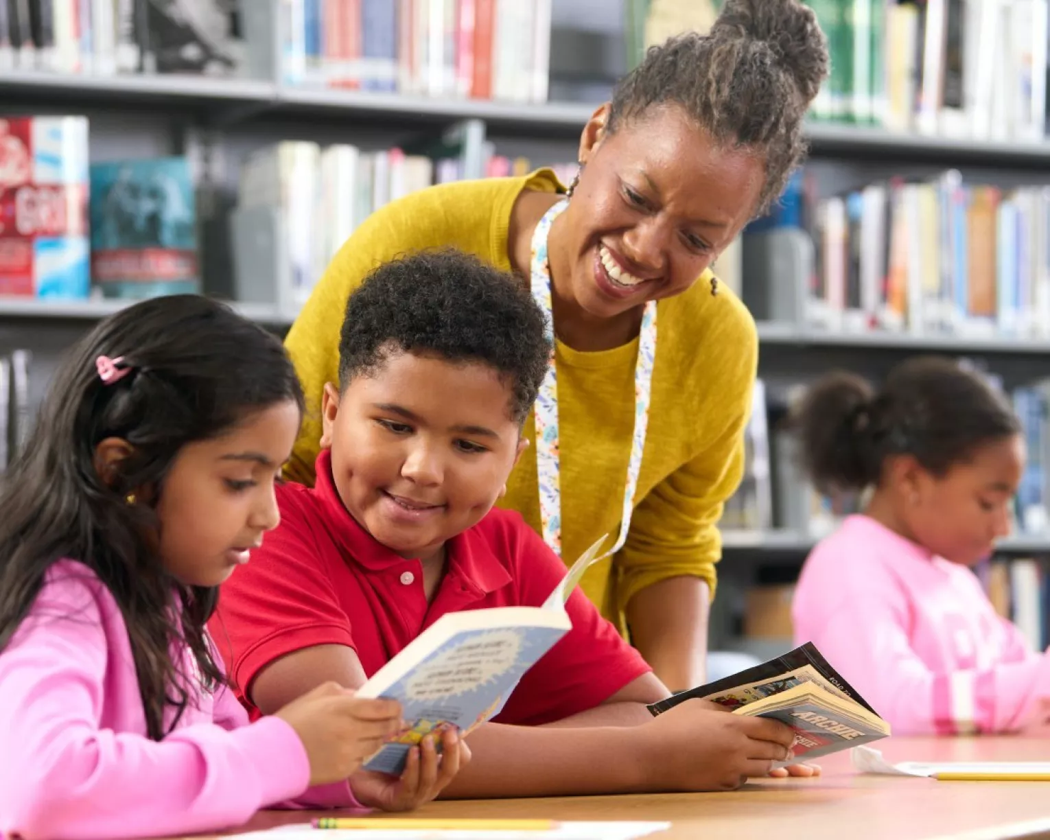 A librarian working with students in a school library