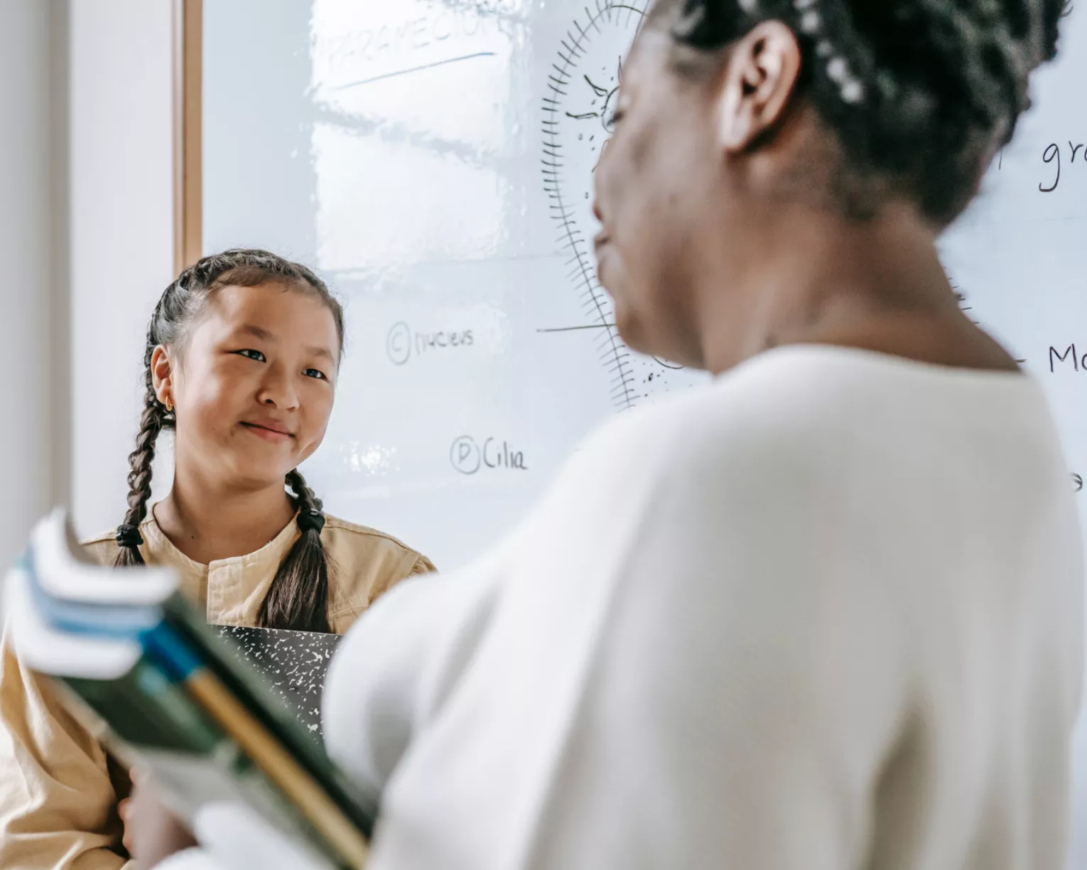 a teacher and student having a one-on-one conversation