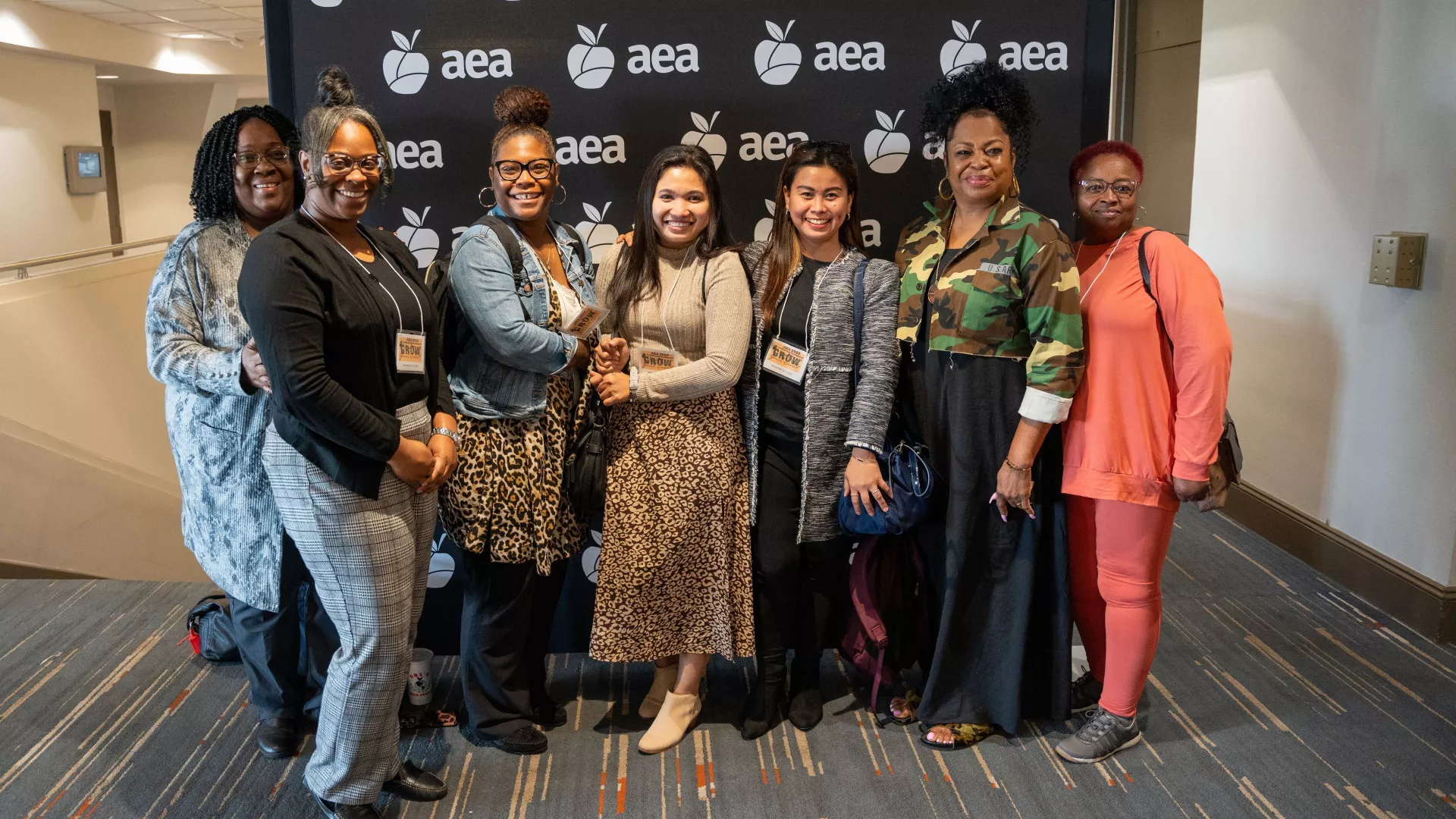 AEA members in front of backdrop