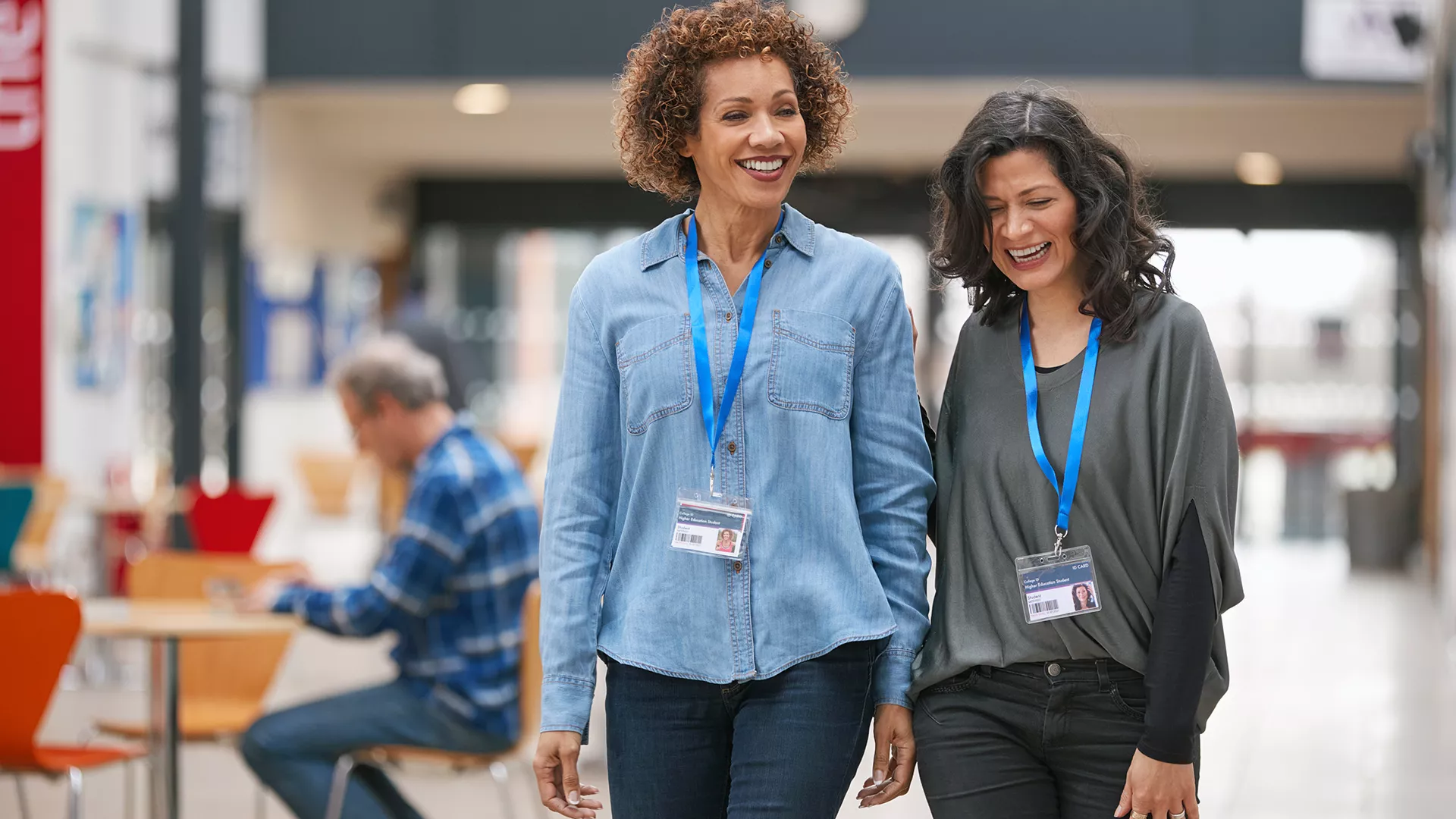 Two women educators walking through a school cafeteria