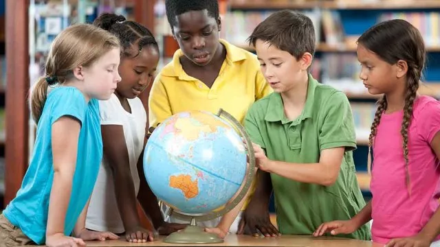 Group of diverse students with globe